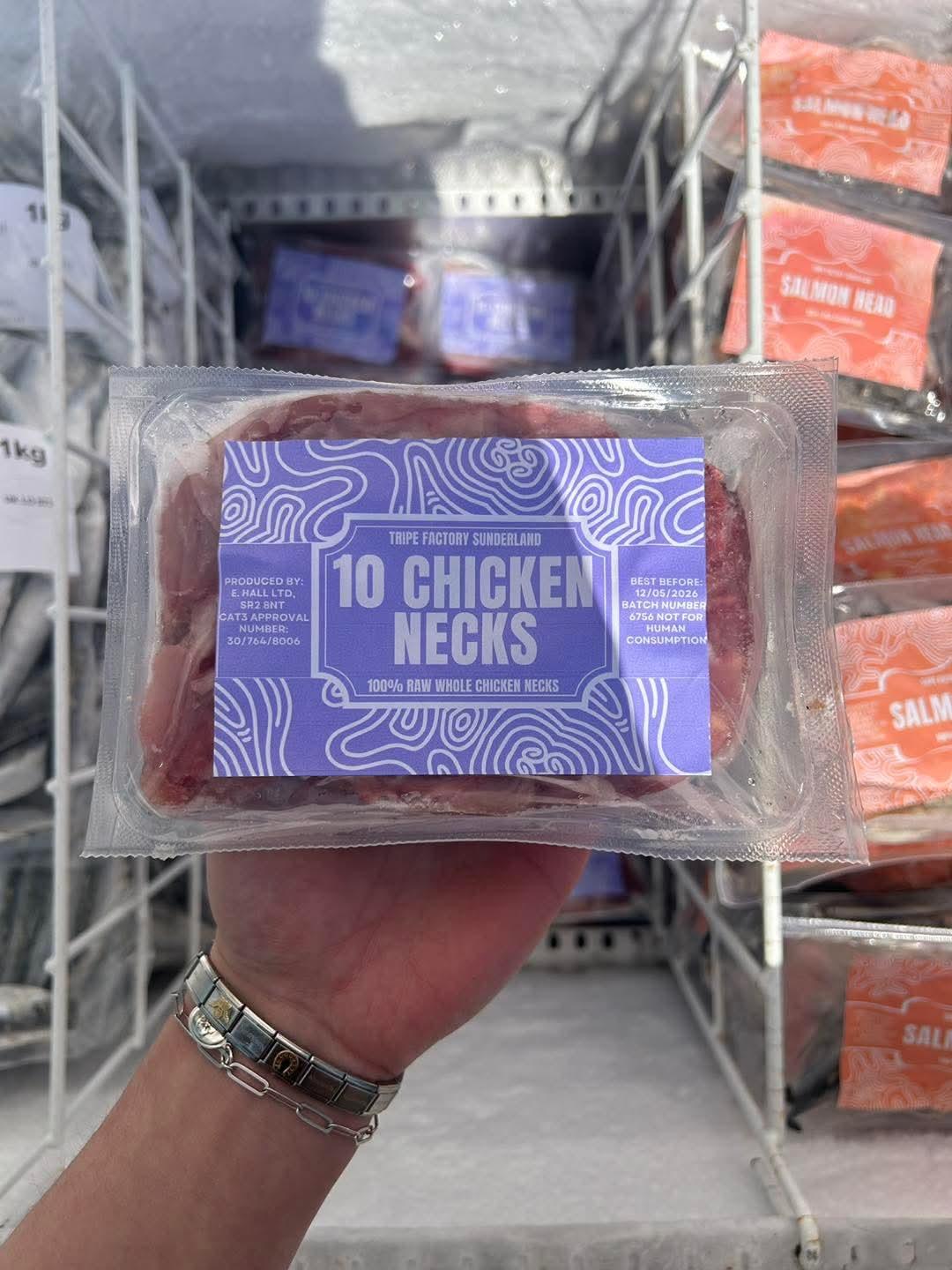 Hand holding packaged 10 chicken necks raw frozen pet treats labeled Tripe Factory Sunderland