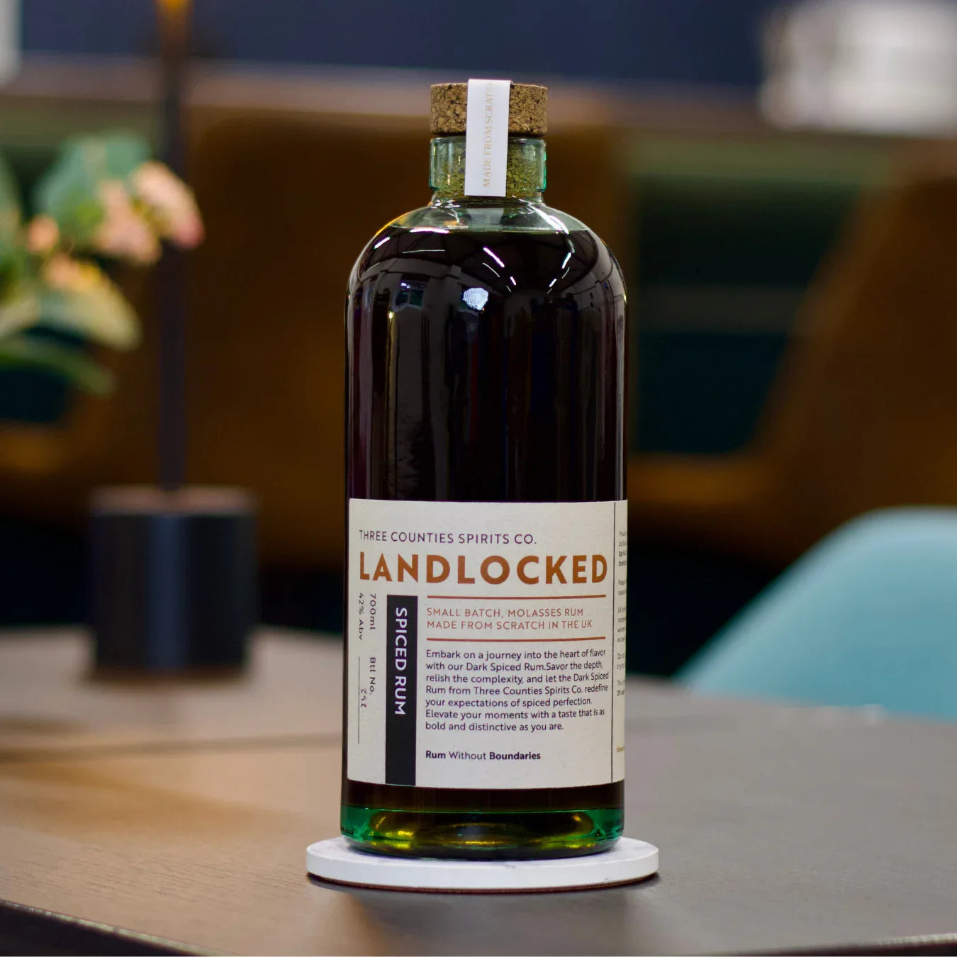 Bottle of Landlocked Small Batch Spiced Rum by Three Counties Spirits Co. on table