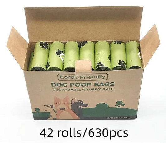 Open box of earth-friendly degradable dog poop bags with green rolls and paw prints, 42 rolls 630 pcs